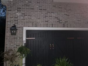 The brick face above the garage doors, the repaired cracks no longer visible.