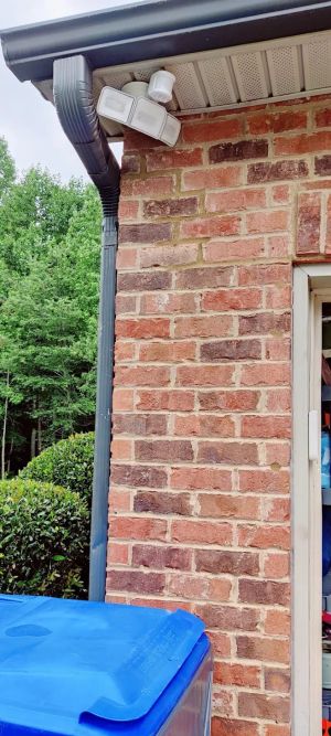 After: the same brick corner with the crack closed and the joints repointed.