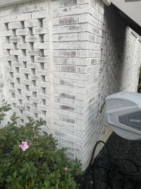 Close view of the column corner where the lattice screen meets the solid brick.