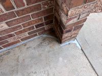 After: the same column back against the slab, the expansion joint filled with flexible sealant.