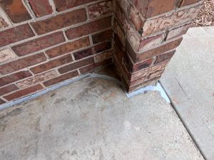 After: the same column back against the slab, the expansion joint filled with flexible sealant.