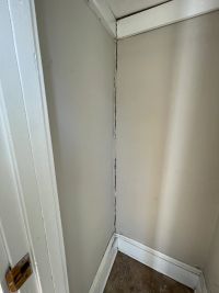Inside the house, a vertical crack running the full height of the corner of the room.