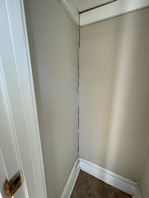 Inside the house, a vertical crack running the full height of the corner of the room.