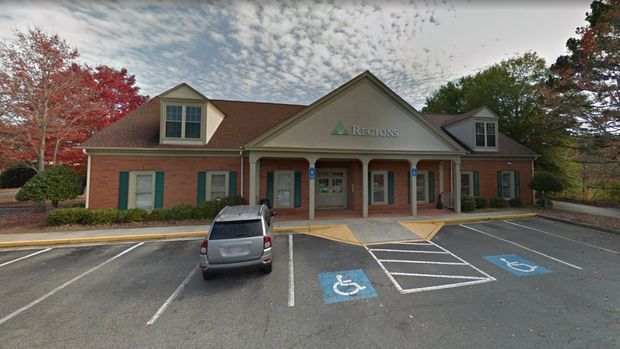 The Regions Bank branch Anglin's customers finance repairs through, seen from its parking lot on an autumn afternoon