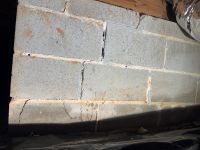 Before: cracked and open mortar joints in the block foundation wall in the crawl space.