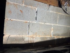 Before: cracked and open mortar joints in the block foundation wall in the crawl space.