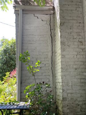 Closer view of the same separation, the crack running from the roof line all the way to the ground.