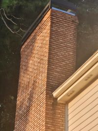 Looking up the chimney from below, where it passes the eave beside the garage.