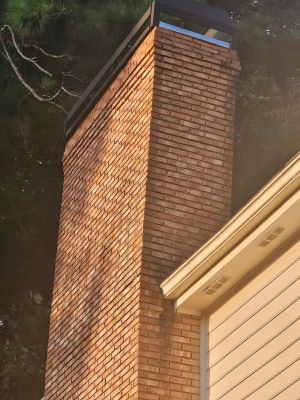 Looking up the chimney from below, where it passes the eave beside the garage.