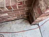 Before: the carport column separated from the concrete slab, an open expansion joint running along the base.