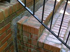 Front steps that have settled and separated from the house.