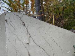 A retaining wall leaning out of plumb before repair.