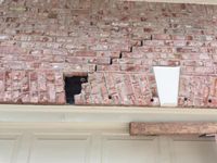 Cracking above a garage door opening, a common sign the lintel or the footing below it has moved.
