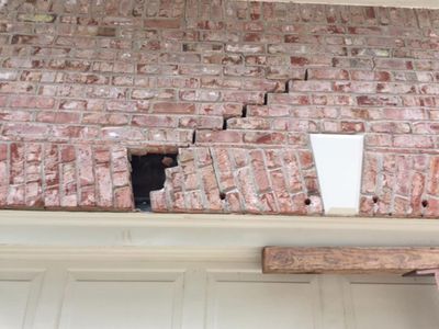 Cracking above a garage door opening, a common sign the lintel or the footing below it has moved.