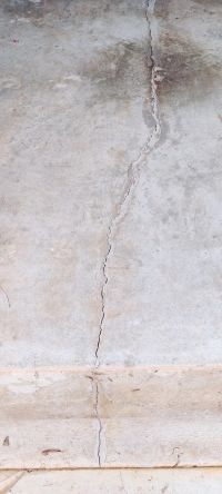 The crack in the concrete slab, filled and sealed along its length.
