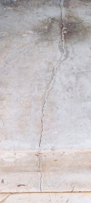 The crack in the concrete slab, filled and sealed along its length.