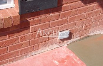 brick wall with cracks between the bricks after they've been fixed and filled