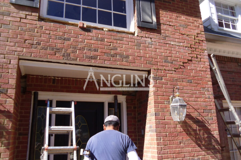 anglin employee repairing cracks in a wall of a house