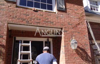 anglin employee repairing cracks in a wall of a house