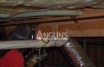 an anglin employee welding a support beam