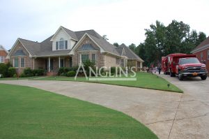 building that needs repair with anglins truck and trailer next to it