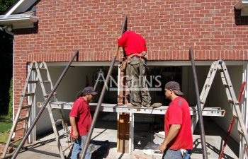 three anglin employees working on two garage doors