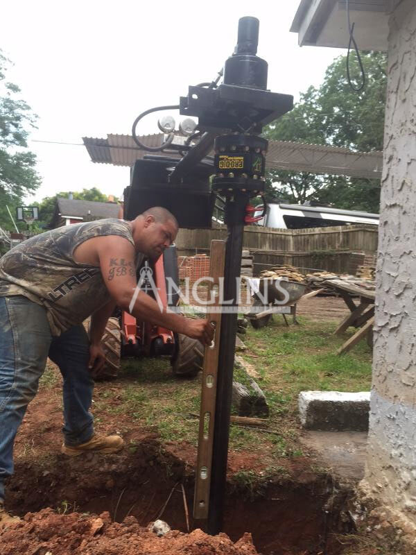 anglin's employee leveling a helical pier