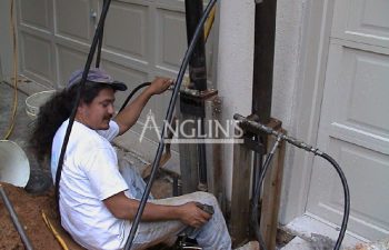 an anglin employee setting up two hydraulic piers
