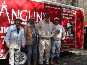 four anglin employees next to an anglin trailer