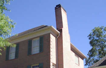 a brick building with a tilt chimney