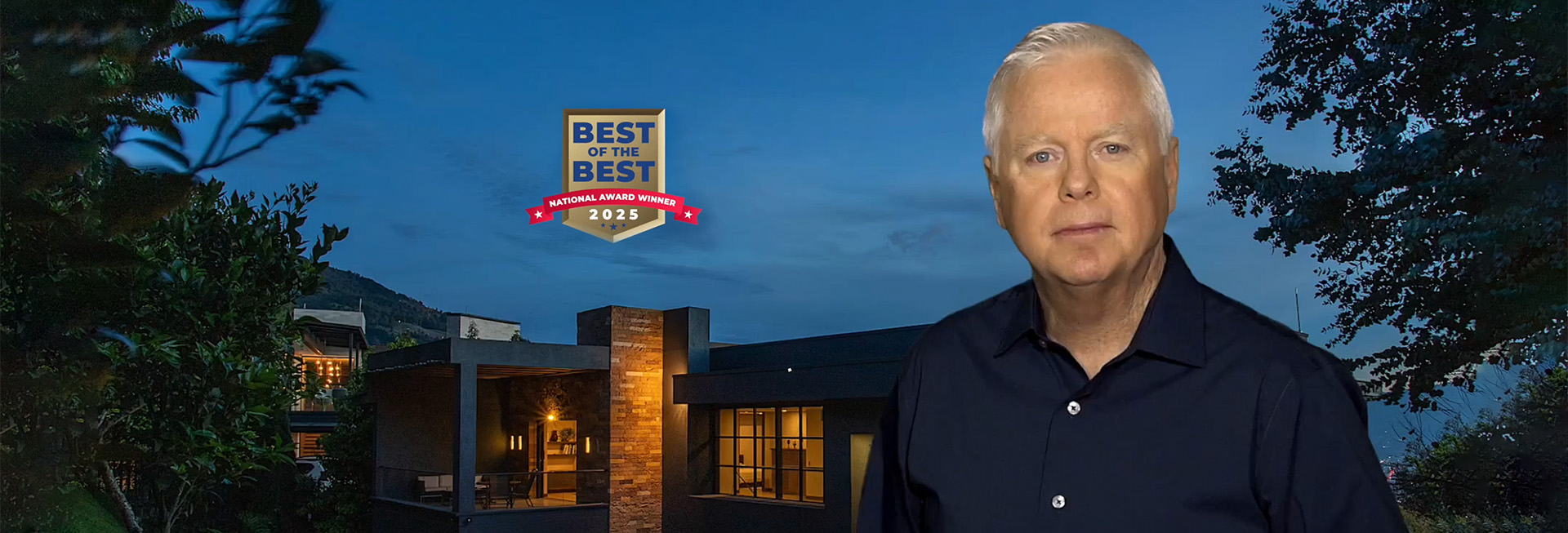 A man in a dark shirt stands in front of a modern house at dusk, with a “Best of the Best National Award Winner 2025” badge displayed above him.